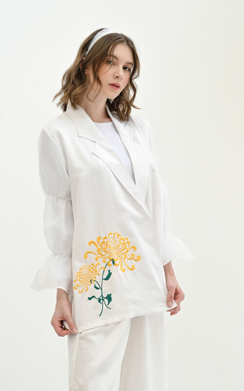 Blazer Warna Putih dengan Lengan Serut Karet dan Bordir Bunga di Sisi Bawah Kanan